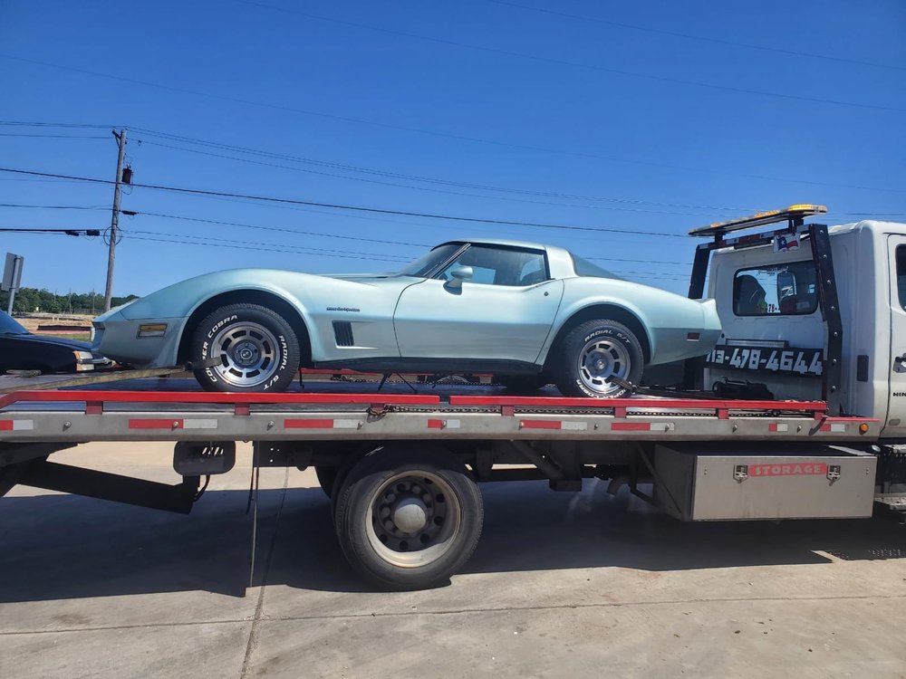 Silver Corvette secured on a flatbed - AA Affordable Towing