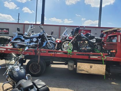 Motorcycles lined up on a red flatbed