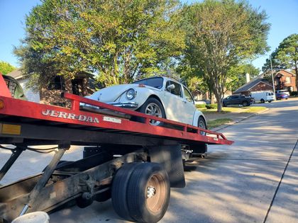 White sports car on a tilted flatbed