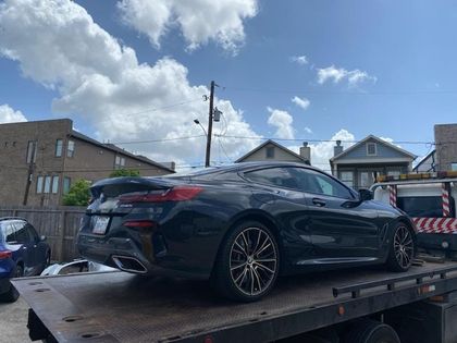 Black BMW secured for vehicle transport