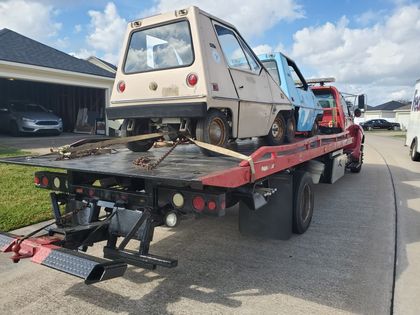 Utility vehicle secured on a flatbed truck