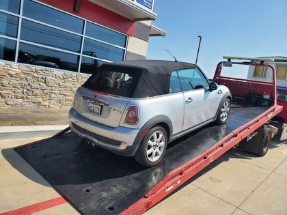 Silver Mini convertible on a flatbed