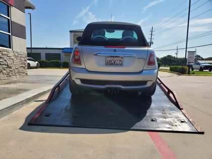 Rear view of a Mini convertible secured for transport