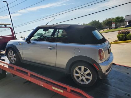 Side view of a Mini convertible on a flatbed
